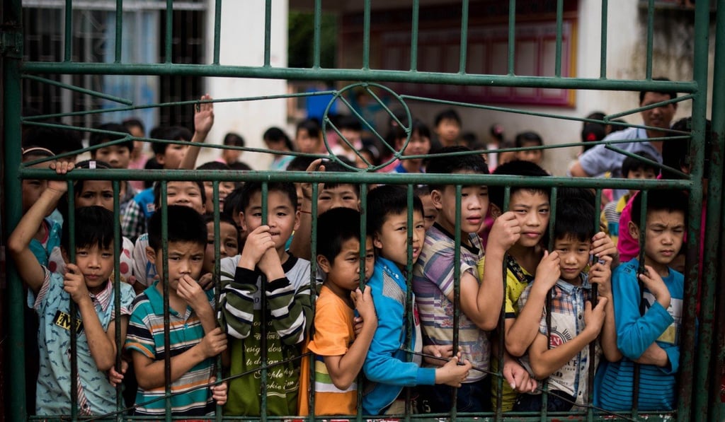 Students gather at the gates of Xianghe Primary School, in the town of Xianghe, in southern China's Guangxi autonomous region. Photo: AFP