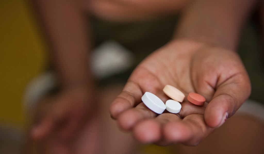 An Indian child is given her daily antibiotic medication for tuberculosis. Photo: Alamy Stock Photo