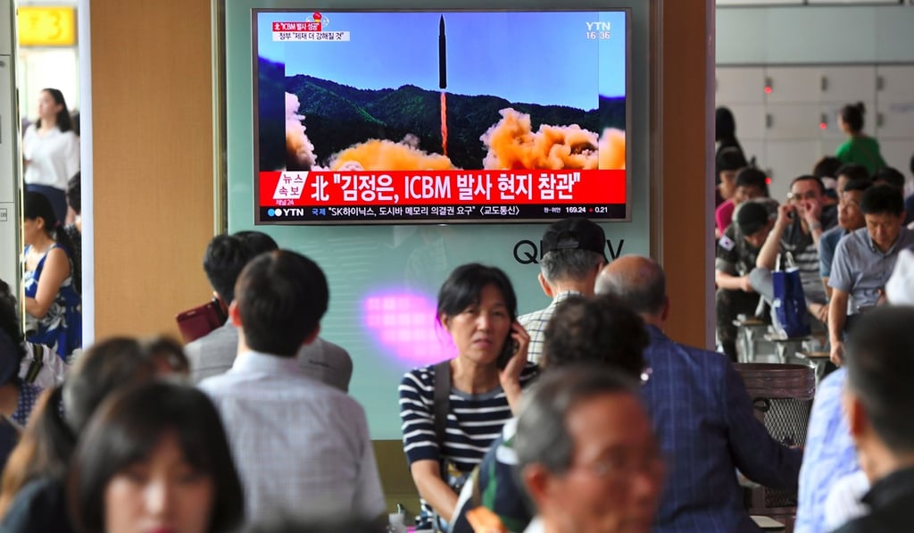 Commuters at a railway station in Seoul watch a TV news broadcast about North Korea’s test launch of an intercontinental ballistic missile, on July 4. Photo: AFP Commuters at a railway station in Seoul watch a TV news broadcast about North Korea’s test launch of an intercontinental ballistic missile, on July 4. Photo: AFP
