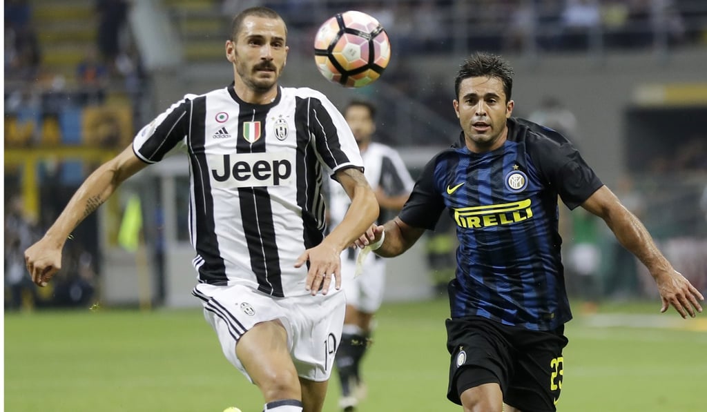 Juventus' Leonardo Bonucci, left, and Inter Milan's Eder go for the ball during a soccer match in Milan, Italy. Retailer Suning bought a 69 per cent stake in the Inter Milan football club. Photo: AP