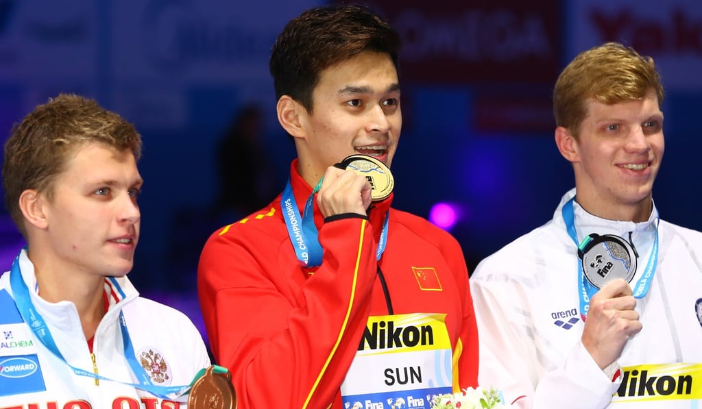 Sun Yang (centre) celebrates his win in the men's 200m freestyle final.