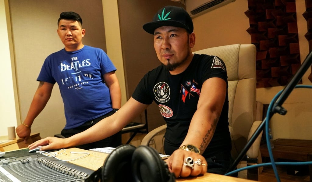 Battogtokh Odsaikhan (right) adjusts the mix on the console in a recording studio. Photo: Reuters