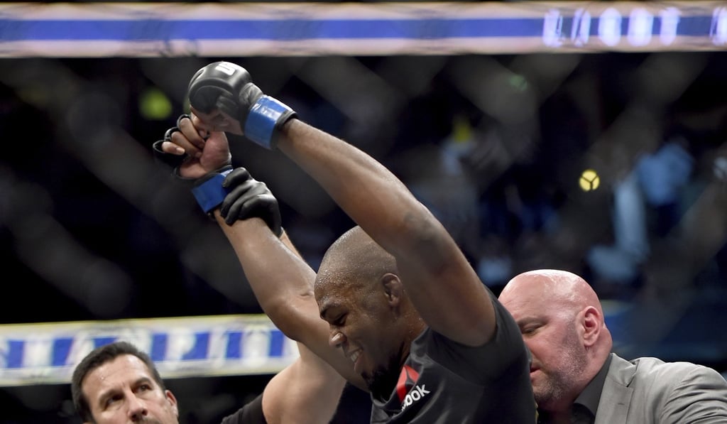 UFC president Dana White puts the UFC light heavyweight championship belt around Jon Jones’ waist. Photo: AP