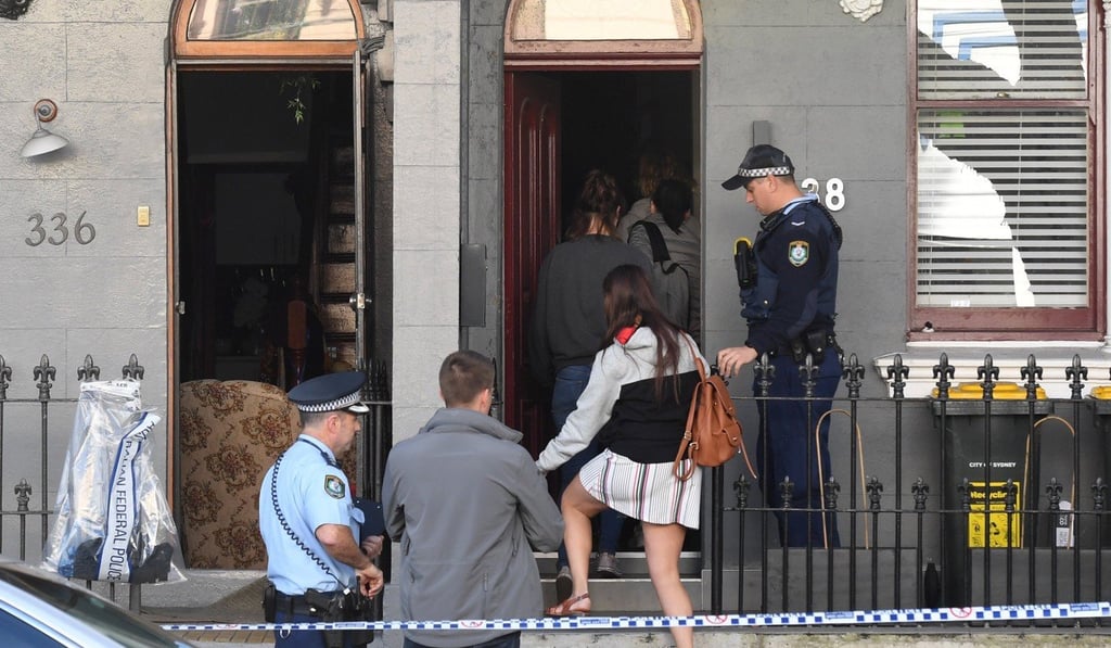 Residents are let back into their Surry Hills, Sydney home next door to a property that was raided by police. Photo: EPA
