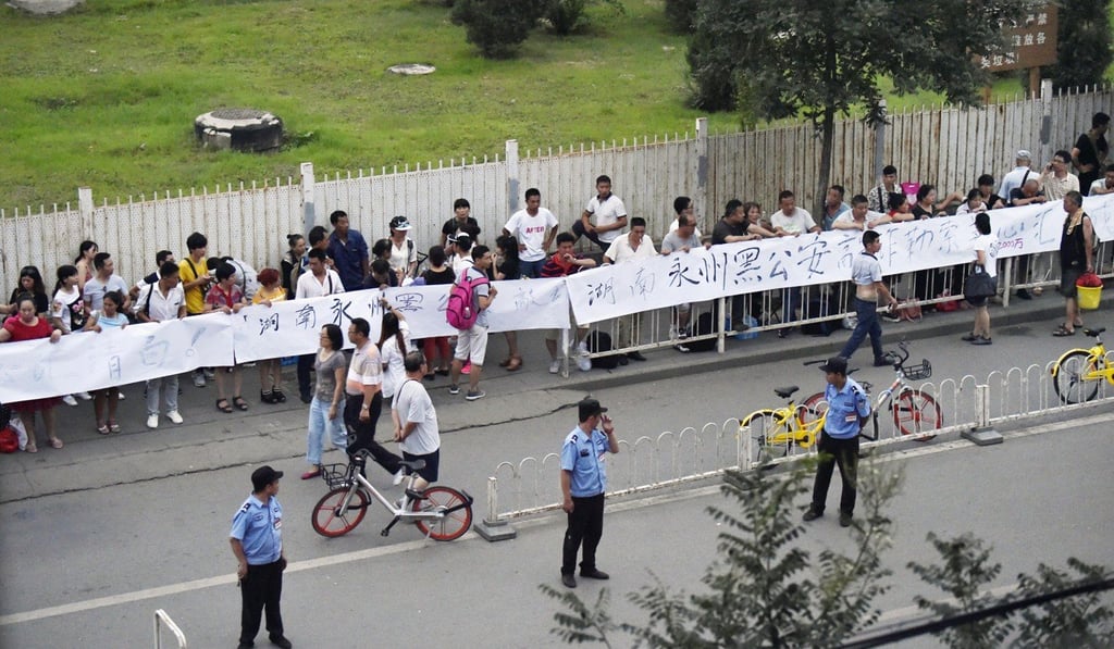 People stage a rare large-scale protest not far from Tiananmen Square in Beijing on July 24. Photo: Kyodo People stage a rare large-scale protest not far from Tiananmen Square in Beijing on July 24. Photo: Kyodo
