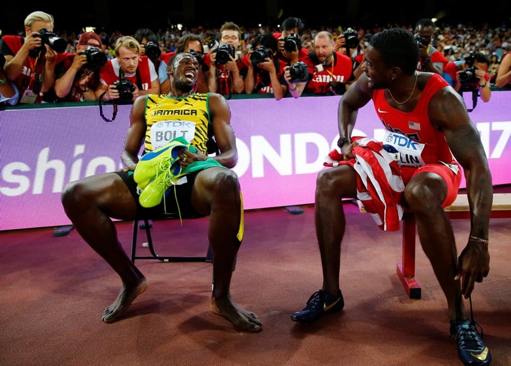 Bolt sits on a bench with Justin Gatlin of US after the 200 metres final at the 15th IAAF World Championships in Beijing in 2015. Photo: Reuters