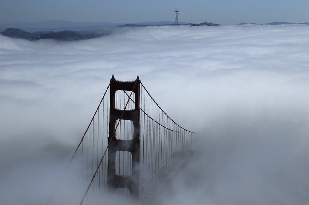 The Golden Gate Bridge shrouded in fog.
