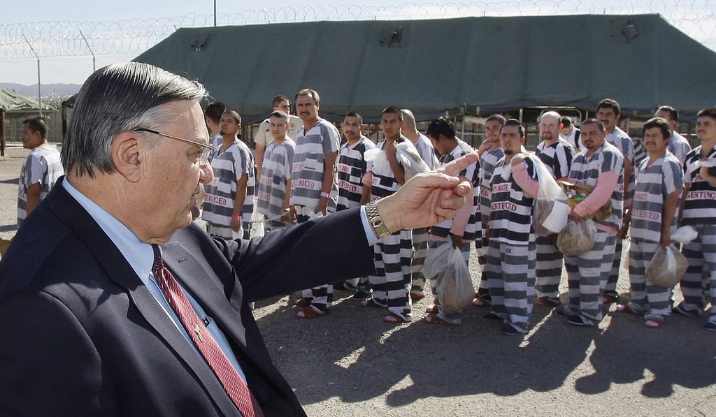 In this February 4, 2009, file photo, Maricopa County Sheriff Joe Arpaio, left, orders approximately 200 convicted illegal immigrants handcuffed together and moved into a separate area of Tent City, for incarceration until their sentences are served and they are deported to their home countries. Photo: AP