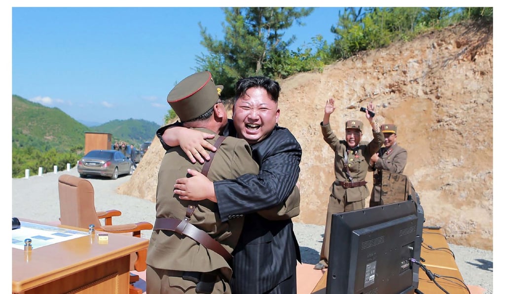 North Korean leader Kim Jong-un celebrates the successful test-fire of an ICBM. Photo: AFP