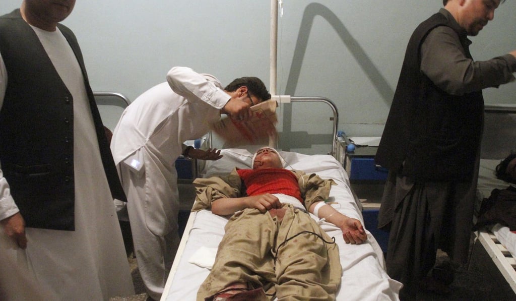 Relatives assist a wounded man in a hospital after a suicide attack on a mosque in Heart, Afghanistan. Photo: AP