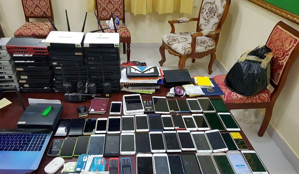 Mobile phones and other equipment confiscated from Chinese nationals in Banteay Meanchey province. Cambodia has arrested more than 200 Chinese men and women suspected of running an online scam that persuaded victims to send nude photographs then extorted them for cash. Photo: AFP