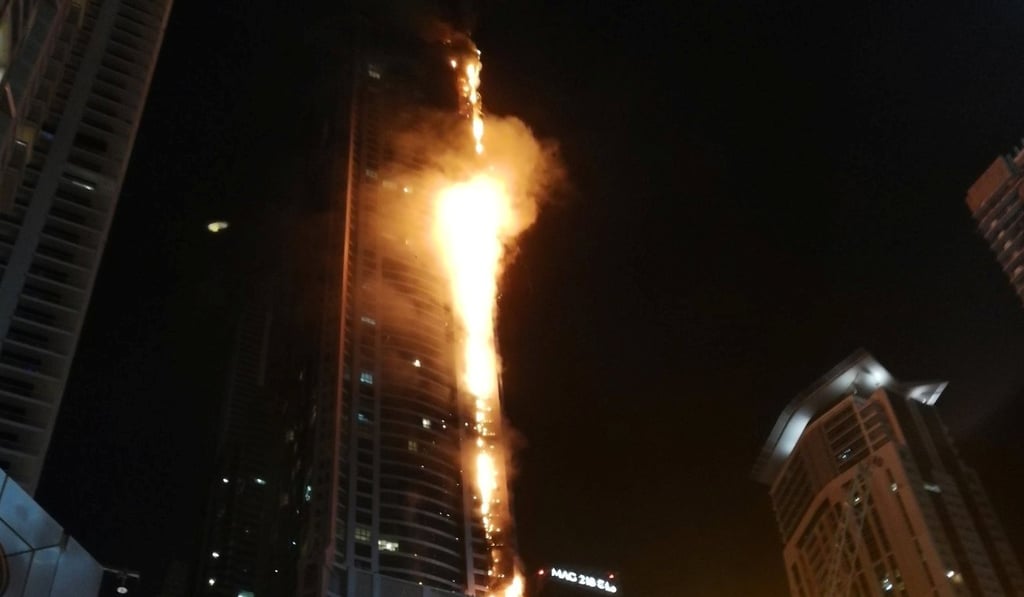 Flames shoot up the sides of the Torch tower residential building in the Marina district, Dubai, United Arab Emirates. Photo: Mitch Williams / @MitchGWilliams