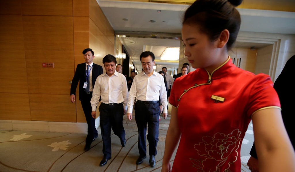 Wang Jianlin, chairman of Dalian Wanda Group, and Sunac China Holdings’ Sun Hongbin arrive for a strategic cooperation signing ceremony in Beijing, on July 19. Photo: Reuters