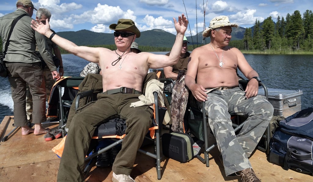Putin fishing at the cascade of mountain lakes. Photo: EPA Putin fishing at the cascade of mountain lakes. Photo: EPA