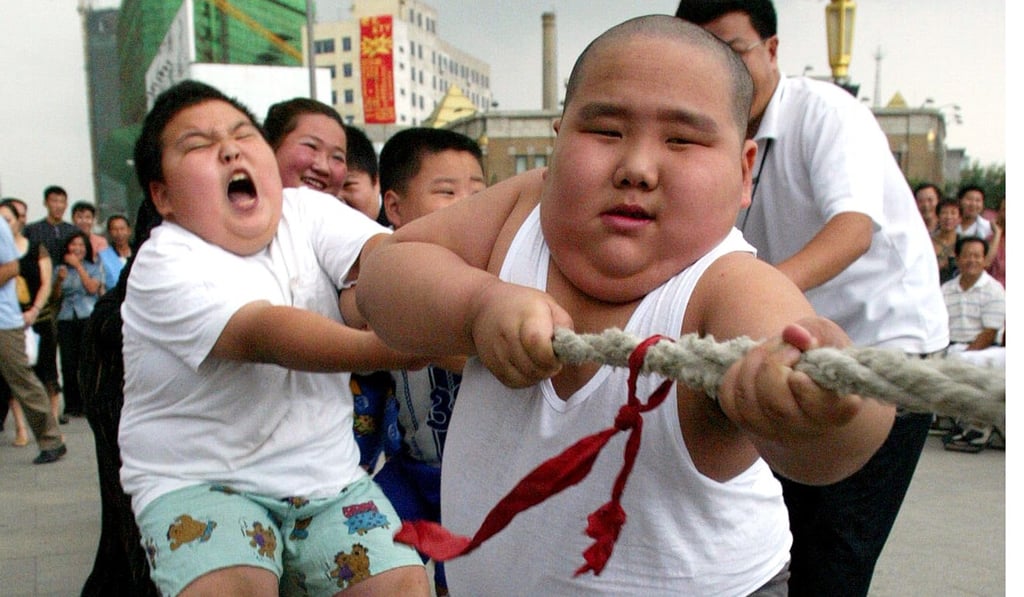 Obese children from a boot camp to combat obesity take part in a tug of war in Shenyang, northeastern China's Liaoning province. Photo: Associated Press