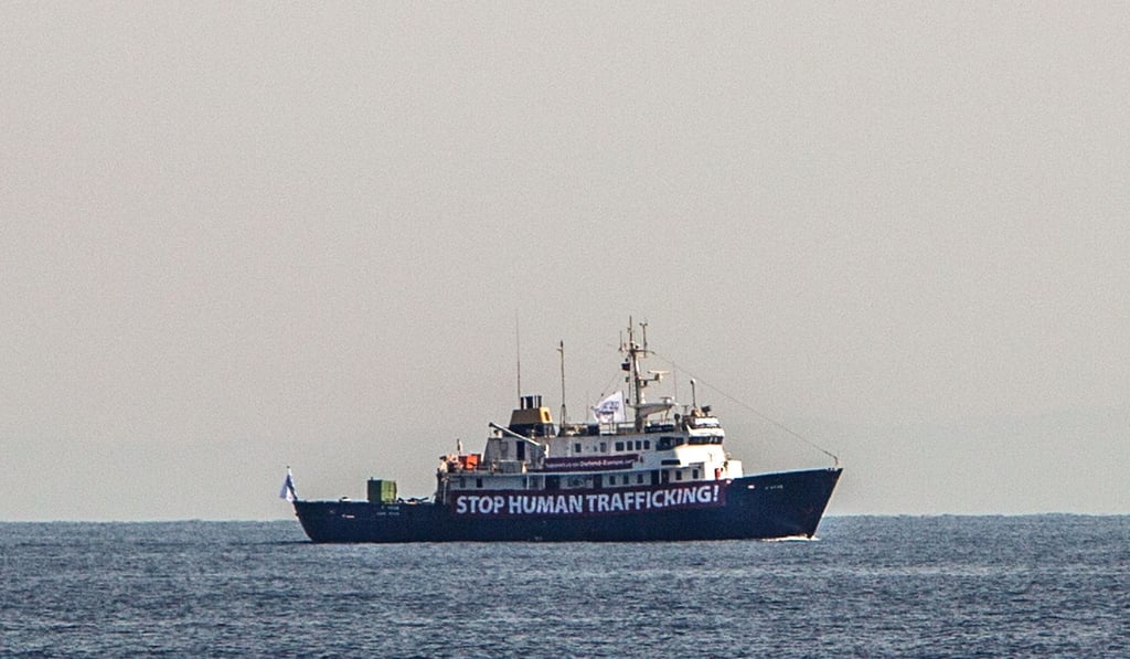 A banner that reads, “Stop Human Trafficking” is attached to the side of the C-Star as it sails in the Mediterranean Sea, 20 nautic miles off the Libyan coast. Photo: AFP