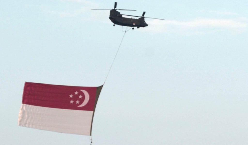 A helicopter from Singapore’s air force takes part in the National Day celebrations. Photo: AFP