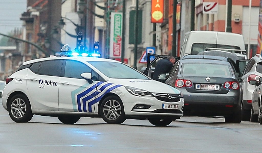 Police cars at the scene where a man was arrested in Molenbeek, Brussels, Belgium. Photo: EPA