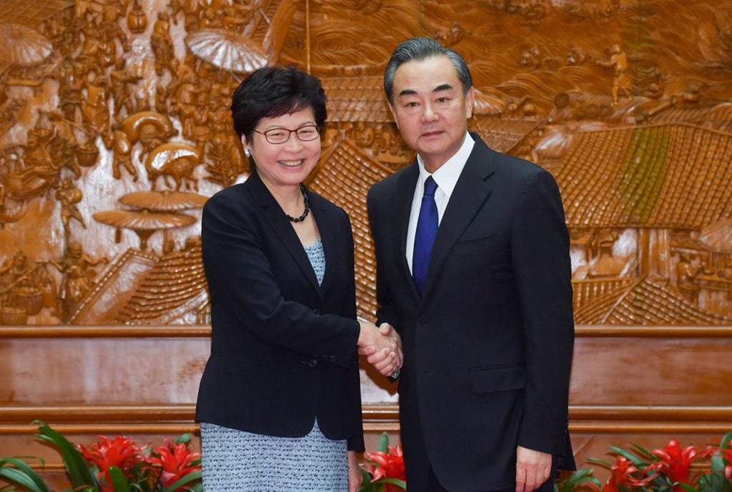 Carrie Lam shakes hands with foreign minister Wang Yi in Beijing. Photo: ISD