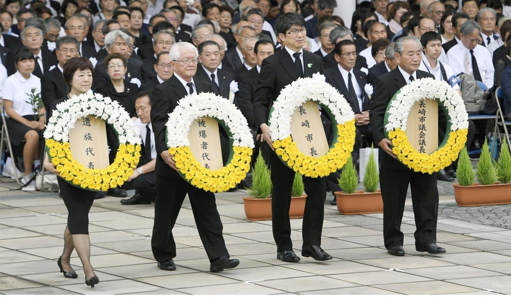 Nagasaki Mayor Tomihisa Taue (2nd from right) offers a wreath of flowers during a memorial ceremony at the Peace Park in Nagasaki on August 9, 2017. Photo: Kyodo Nagasaki Mayor Tomihisa Taue (2nd from right) offers a wreath of flowers during a memorial ceremony at the Peace Park in Nagasaki on August 9, 2017. Photo: Kyodo