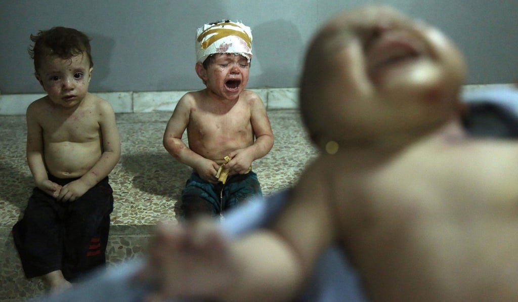 Injured Syrian children cry as they wait to receive treatment at a makeshift hospital in Jobar on August 5, following a reported government air strike in the Ghouta area, a rebel stronghold east of the capital Damascus. The Trump administration’s ceasefire agreement with Russia, which perpetuates Iran’s unhelpful presence in Syria, underscores a visceral America First strategy for dealing with Damascus. Photo: AFP