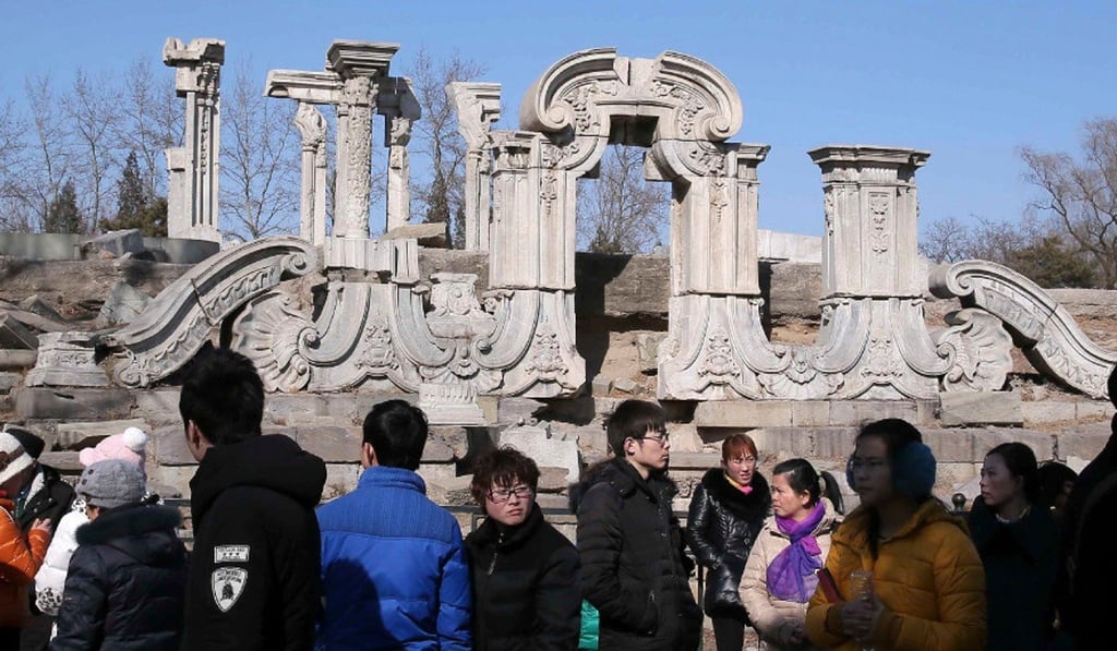 Visitors look at one of the ancient stone relics at the Old Summer Palace in Beijing. Photo: AFP Visitors look at one of the ancient stone relics at the Old Summer Palace in Beijing. Photo: AFP