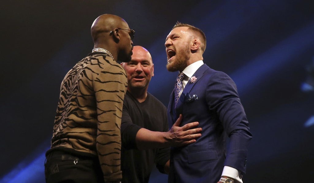 Connor McGregor (right) and Floyd Mayweather are separated by UFC president Dana White at the SSE Arena in Wembley, London. Photo: AP