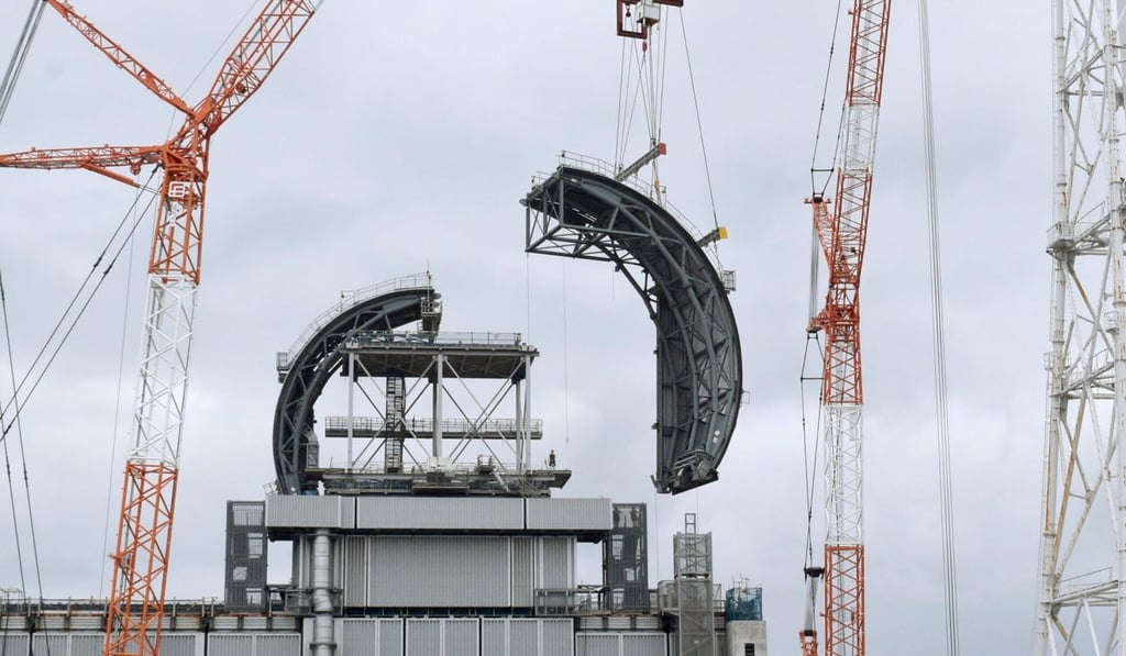 Part of a roof cover is placed on top of the No. 3 reactor building of Fukushima Daiichi nuclear power plant. Photo: Kyodo