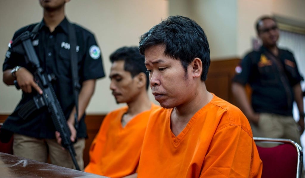 Indonesian narcotics police guard two suspects in Jakarta. Photo: AFP