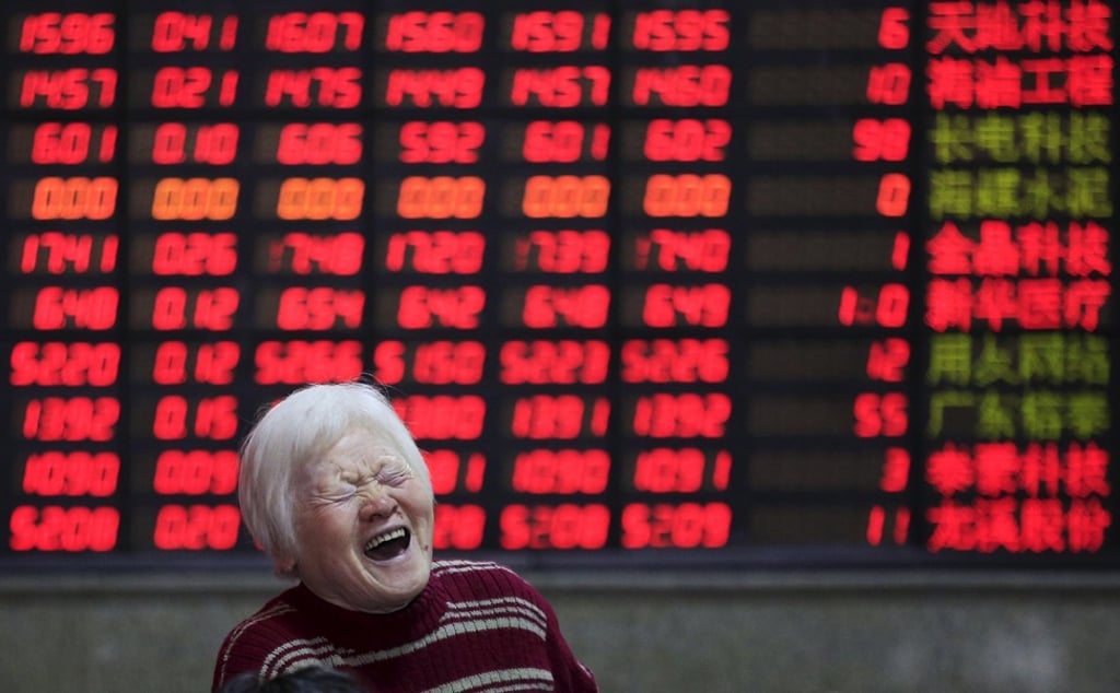 An investor in front of an electronic board showing stock information at a brokerage house in Shanghai on March 7, 2016. Contrary to global conventions, China’s stock market depicts gains and advances in red, showing declines in green. Photo: Reuters.