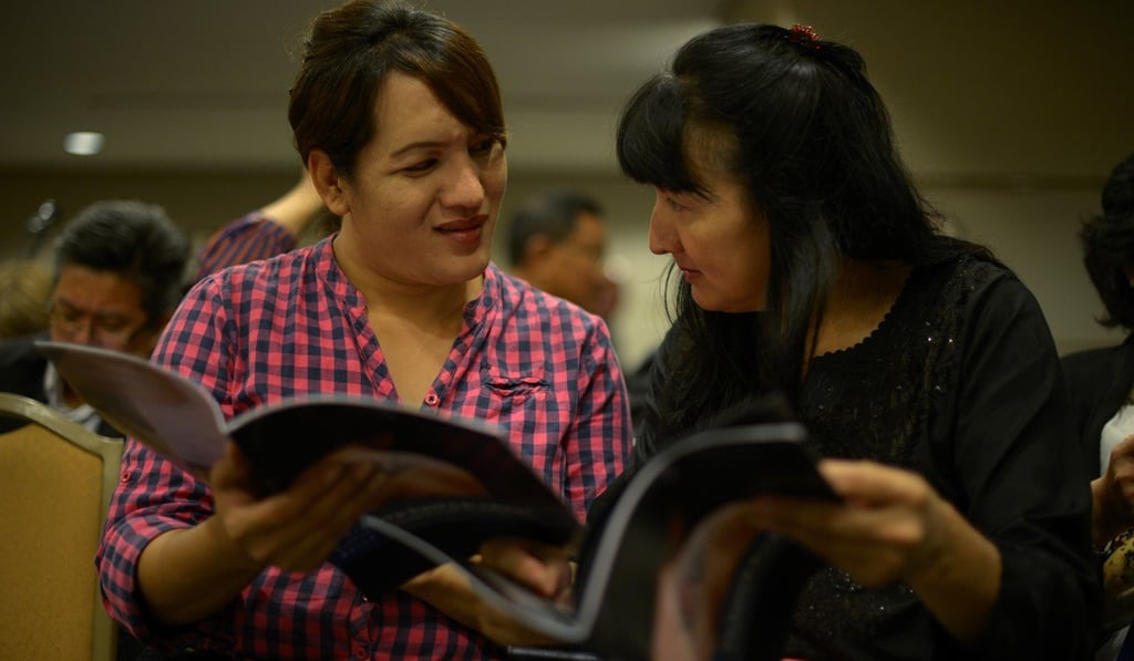 Transgender women talk to each other as they hold reports from Human Rights Watch on abuses against transgender people in Kuala Lumpur. Some fear members of the LGBT community may soon be targeted in Malaysia to distract the public before elections. Photo: AFP