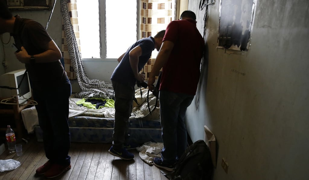 Police check the room of a suspected child webcam cybersex operator in the Philippines. Photo: AP