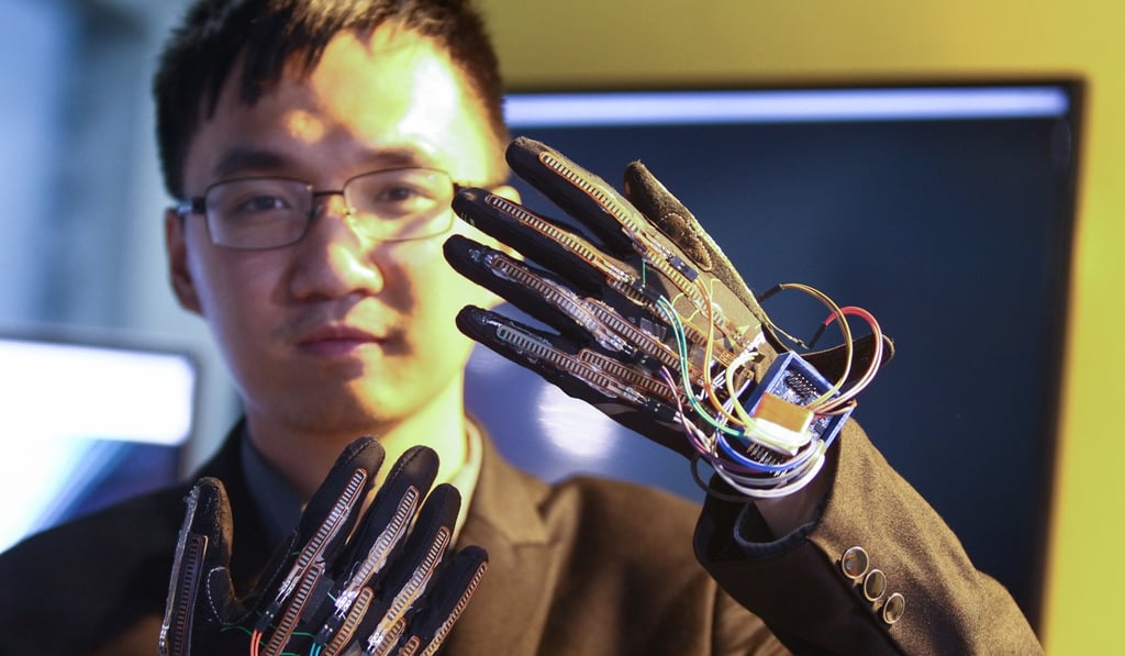 A Chinese tech firm staff shows how gloves developed with artificial intelligence technology can provide real-time audio translation of sign language. China wants to be the global leader in AI by 2030. Photo: Simon Song