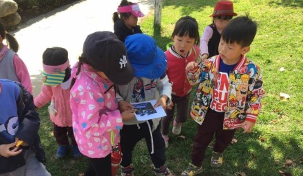 Children at Mao Mao Guo Er participate in an insect-searching task during an outing in March. Photo: Handout.