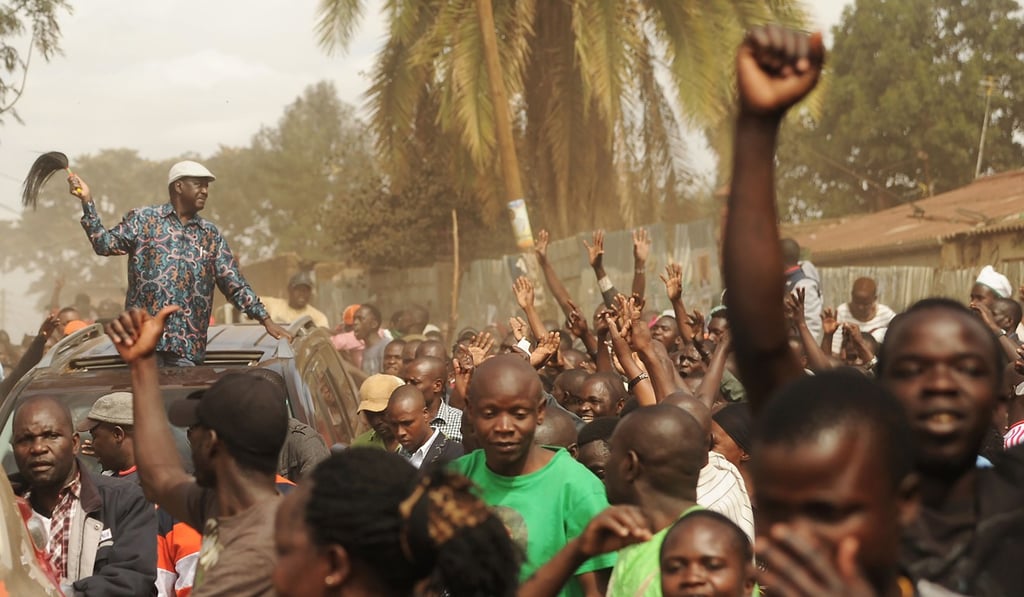 Kenya's opposition leader Raila Odinga waves from his vehicle to supporters as he leaves Kibera slum. Photo: AFP