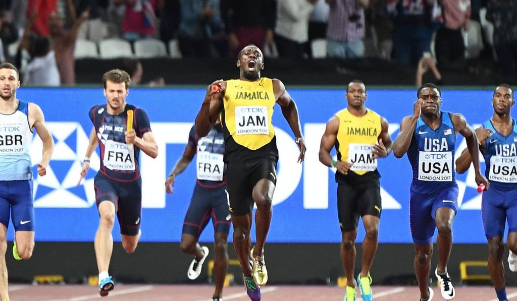Usain Bolt (centre) grimaces in pain after pulling up with an injury. Photo: AFP Usain Bolt (centre) grimaces in pain after pulling up with an injury. Photo: AFP