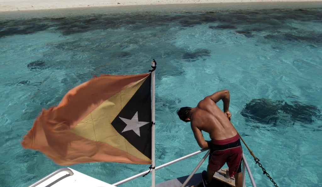 Photograph taken on November 1, 2004 shows a Timorese flag flying on the bow of a boat to a secluded beach on Jaco Island in Lautem District, East Timor. Photo: Daniel J. Groshong