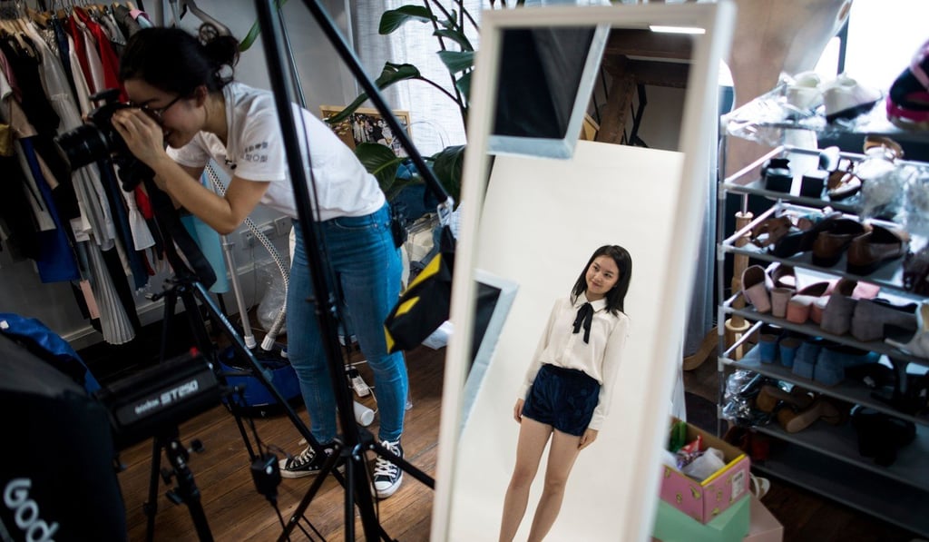 Wang Houhou (left) taking pictures of a model for the website of her e-commerce start-up