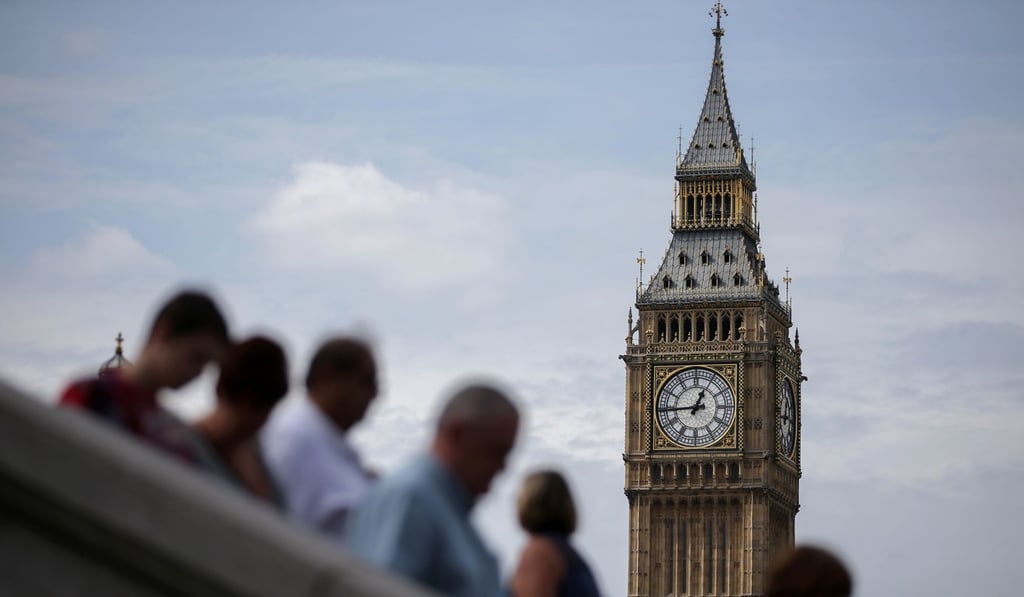 Tourists are pictured on Westminster Bridge beneath one of the four faces of the Great Clock of the Elizabeth Tower, commonly referred to as Big Ben, near the Houses of Parliament in central London. Photo: AFP Tourists are pictured on Westminster Bridge beneath one of the four faces of the Great Clock of the Elizabeth Tower, commonly referred to as Big Ben, near the Houses of Parliament in central London. Photo: AFP