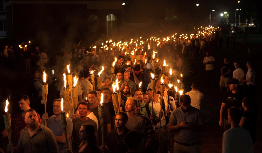 White nationalists carry torches on the grounds of the University of Virginia on Friday, August 11. Photo: Reuters