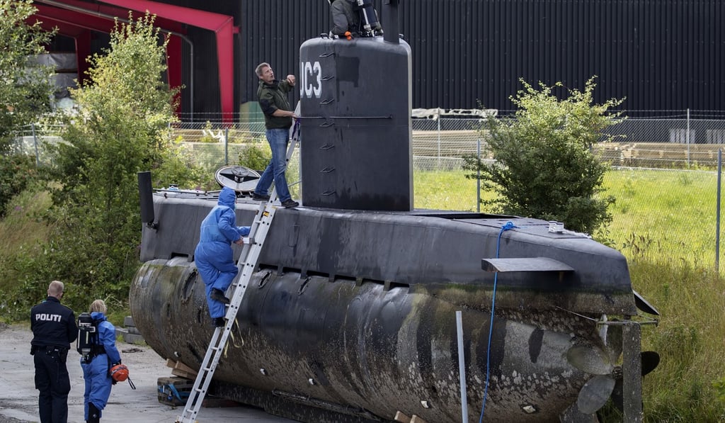 Police technicians board the submarine UC3 Nautilus in Copenhagen harbour. Photo: AP Police technicians board the submarine UC3 Nautilus in Copenhagen harbour. Photo: AP
