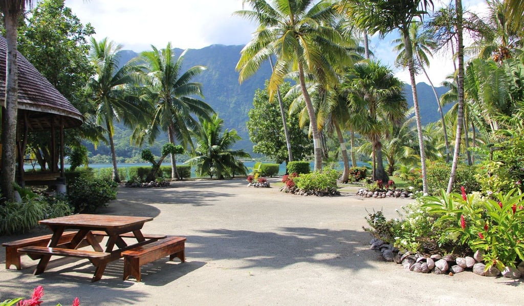 Lush tropical gardens with palm trees and views across the lagoon to the mountains beyond are all part of the package.