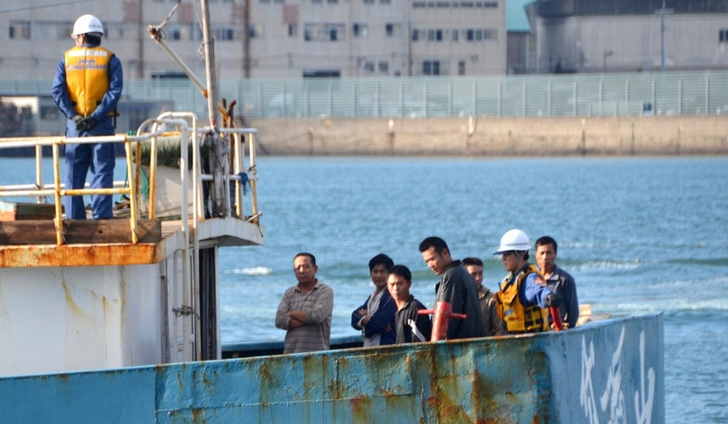 Crew members and Japan Coast Guard officials (wearing helmets) are seen on a Chinese fishing boat at Nagasaki port in Nagasaki, southwestern Japan in 2011. Photo: Kyodo