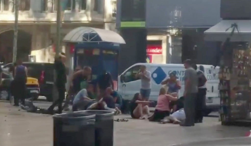 Injured people are helped on Las Ramblas in Barcelona on Thursday after a suspected terrorist attack. Photo: AP