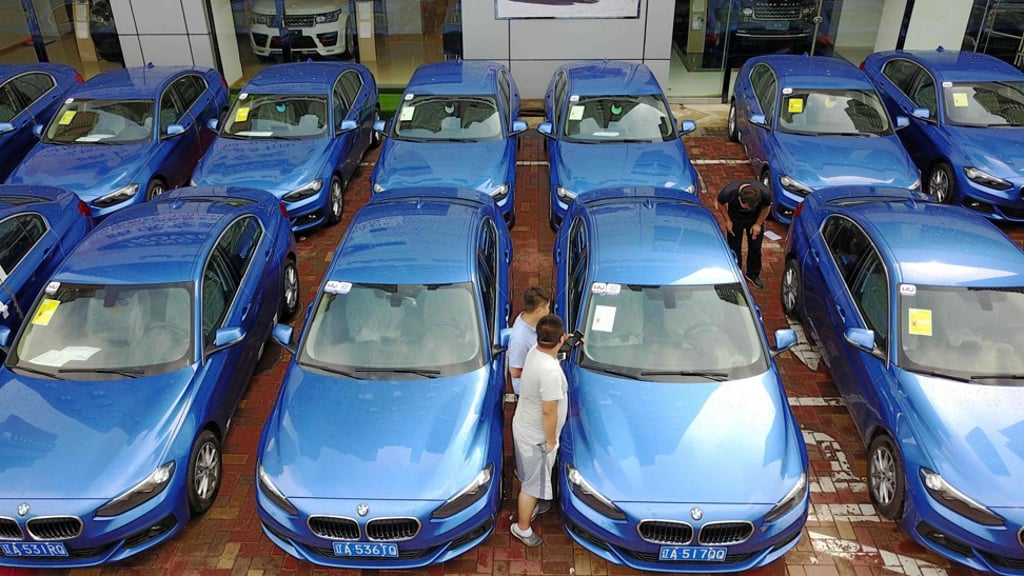 People looking at a BMW 1-Series ‘sharing car’ in Shenyang, China. Photo: AFP