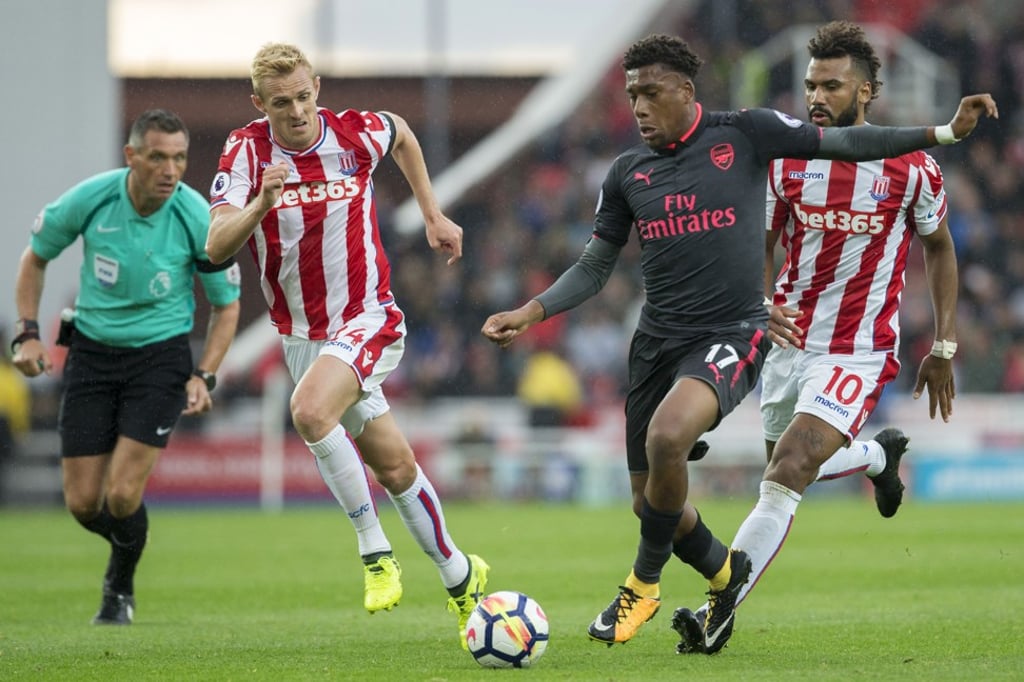 Arsenal’s Alex Iwobi vies with Stoke City’s Darren Fletcher and Eric Maxim Choupo-Moting during the 1-0 Premier League loss. Photo: AFP