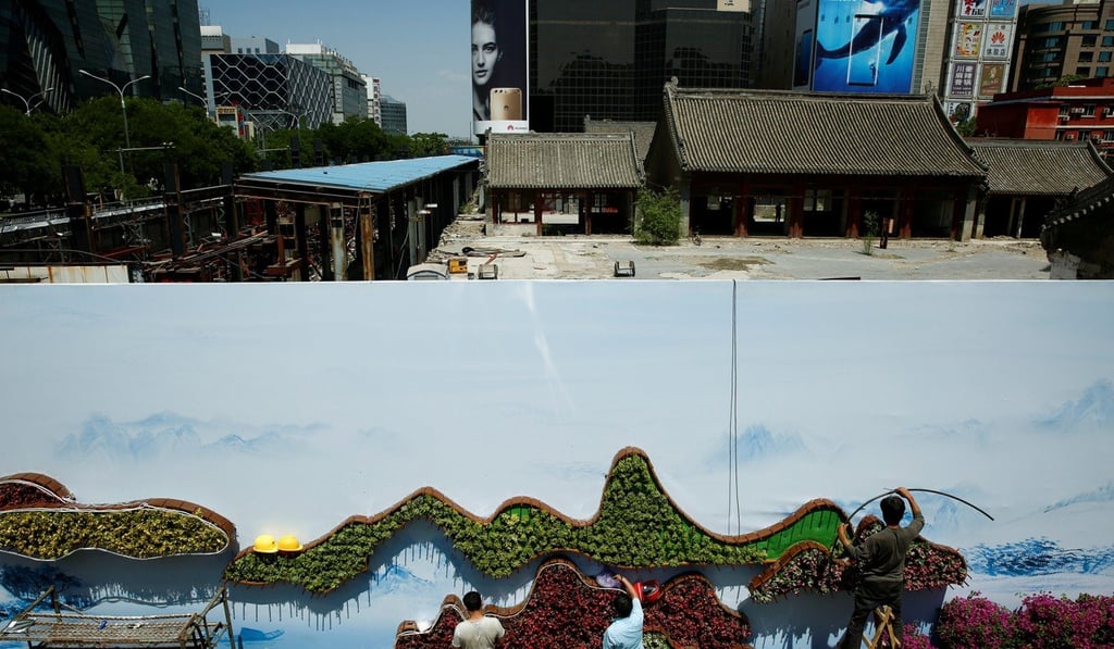 Workers set up a flower display ahead of the Belt and Road Forum in Beijing. Photo: Reuters