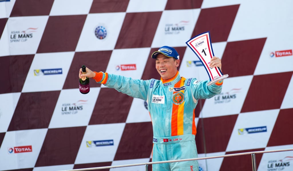 William Lok celebrates on the podium. William Lok celebrates on the podium.