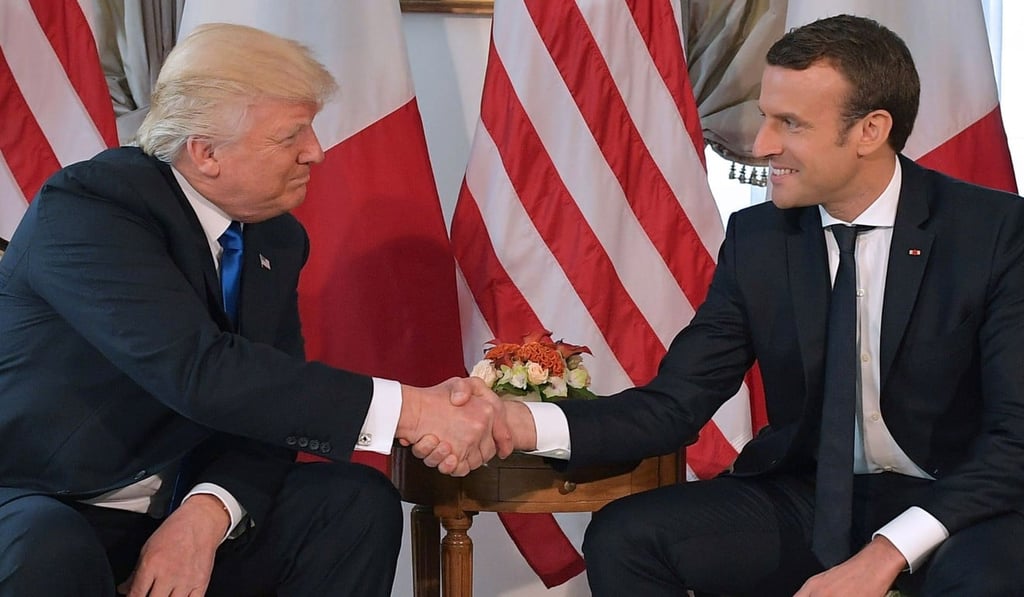 US President Donald Trump (left) and French President Emmanuel Macron shake hands on May 25 on the sidelines of the Nato summit in Brussels. Photo: AFP