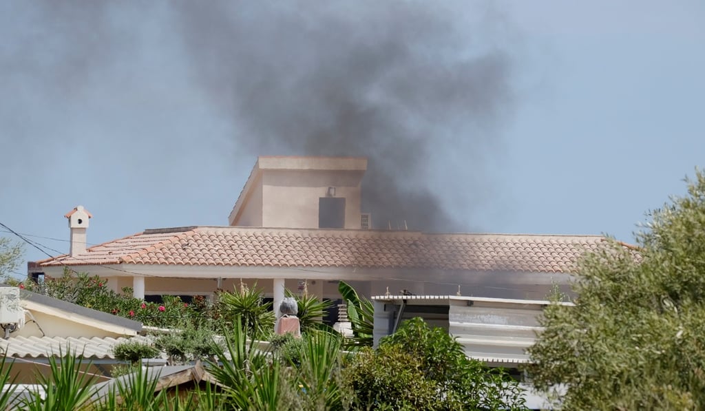 Smoke rises on Sunday from the site of a suspected bomb factory that exploded in Alcanar in Spain four days earlier. Gas cannisters in the rubble at the site have continued to explode in recent days. Photo: Reuters